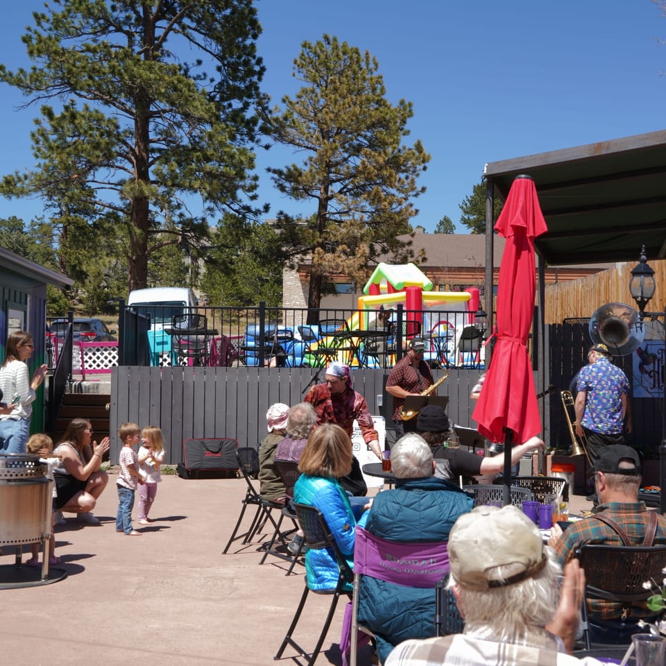 Neighbors gathering for live music on The Hummingbird Club patio